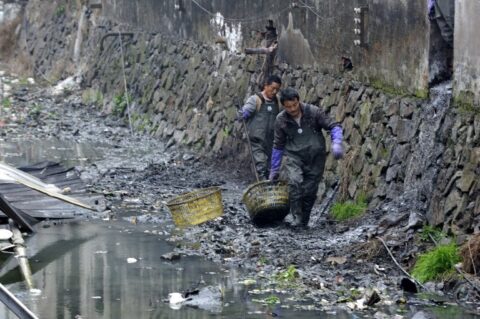 --FILE--Sanitation workers clean up a polluted river in Ruian city, southeast Chinas Zhejiang province, 18 February 2013. Web journalist/activist Deng Fei, a famous guy in Chinas cyberspace, has orchestrated a number of online campaigns, many of them targeted at helping children. During vacation for the Chinese Lunar New Year, Deng has sparked another social media movement by asking a very simple question: How is the river in your hometown? While you are home for the holidays, take a photo of the river or stream in your hometown and upload it to Weibo for us to see. It soon became one of Sinas trending topics, with thousands of net users responding to the call. What is interesting about this is not so much that some Chinese rivers are full of trash -- this should not come as a great shock to anyone -- but that it is a clever way of making a local issue into a national one.